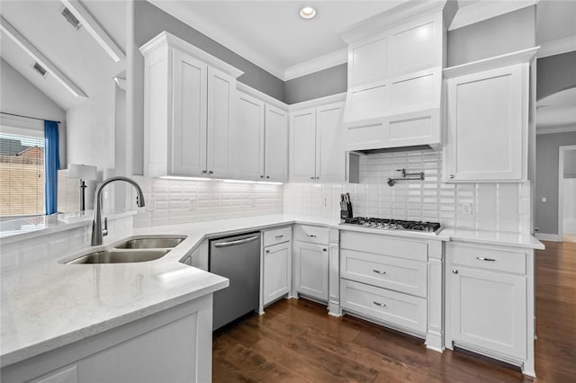 kitchen featuring decorative backsplash, appliances with stainless steel finishes, sink, dark hardwood / wood-style floors, and white cabinetry