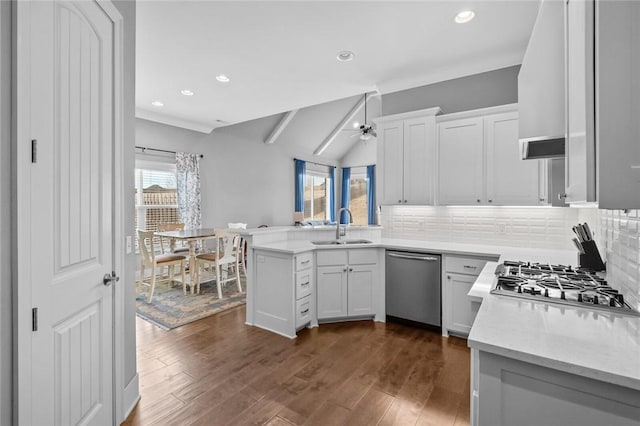 kitchen featuring white cabinetry, sink, stainless steel appliances, tasteful backsplash, and vaulted ceiling