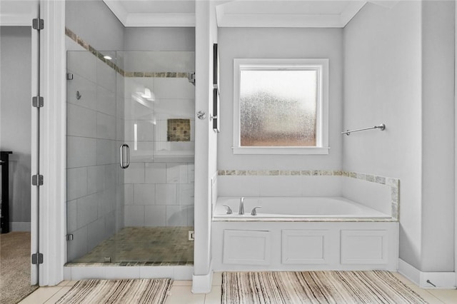 bathroom with tile patterned floors, ornamental molding, and shower with separate bathtub