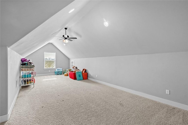 playroom featuring carpet flooring, ceiling fan, and vaulted ceiling