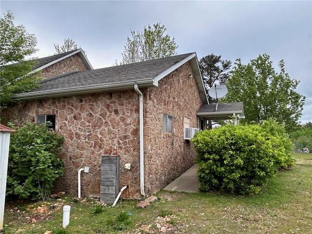 view of side of home with a yard