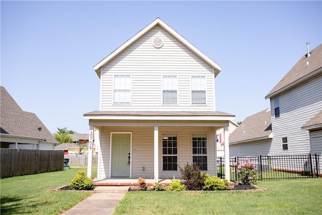 view of front of house with a front yard and fence