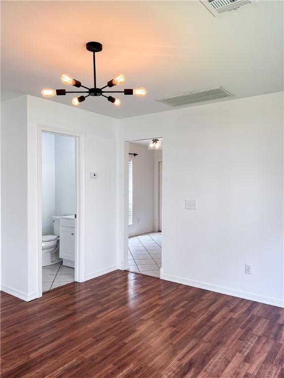 unfurnished room with baseboards, visible vents, and light wood finished floors