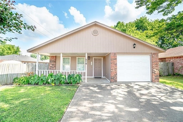 view of front of house featuring a porch, a garage, and a front yard