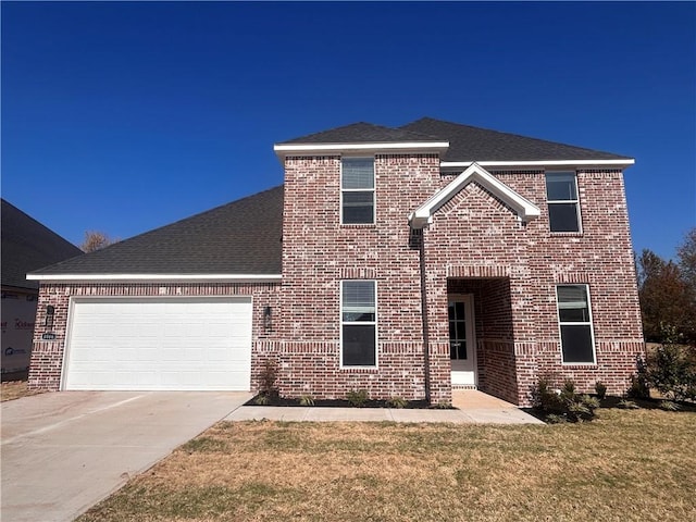 view of front property featuring a garage and a front lawn