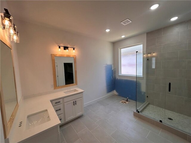 bathroom featuring tile patterned flooring, vanity, and an enclosed shower