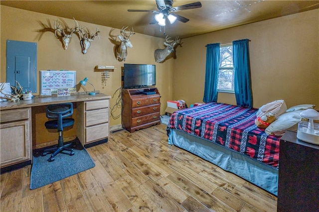 bedroom featuring electric panel, ceiling fan, and light hardwood / wood-style flooring