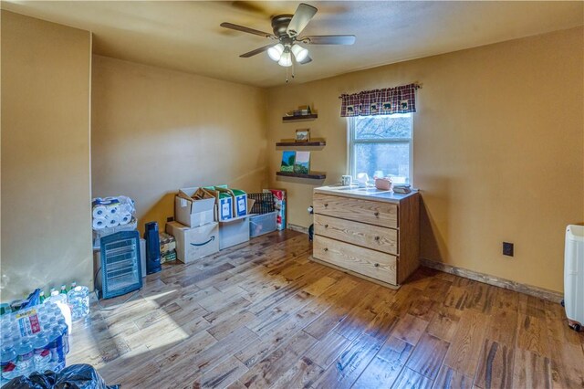 misc room with ceiling fan and light hardwood / wood-style flooring