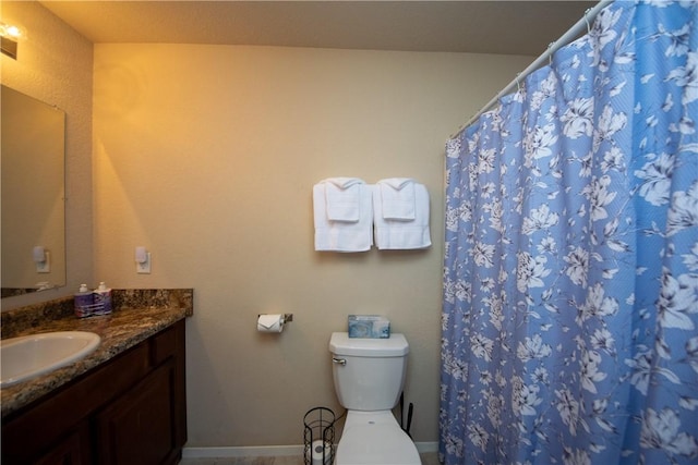 bathroom with toilet, vanity, and a shower with curtain