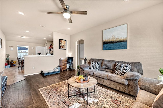 living room featuring ceiling fan and wood-type flooring