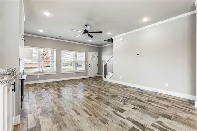 unfurnished living room with light hardwood / wood-style flooring, ceiling fan, and crown molding