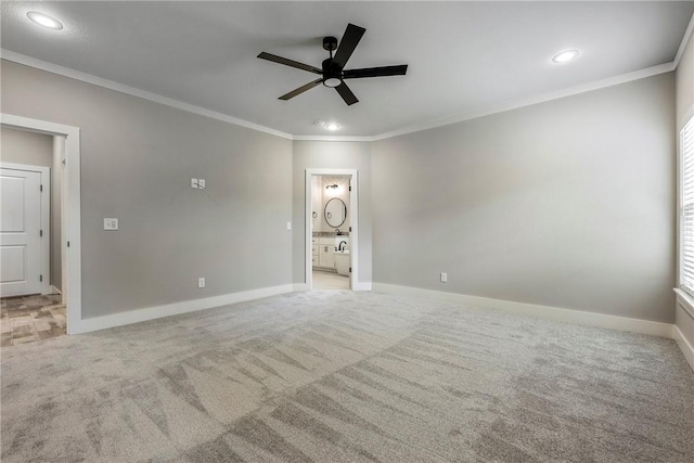 unfurnished room featuring crown molding, ceiling fan, and light colored carpet