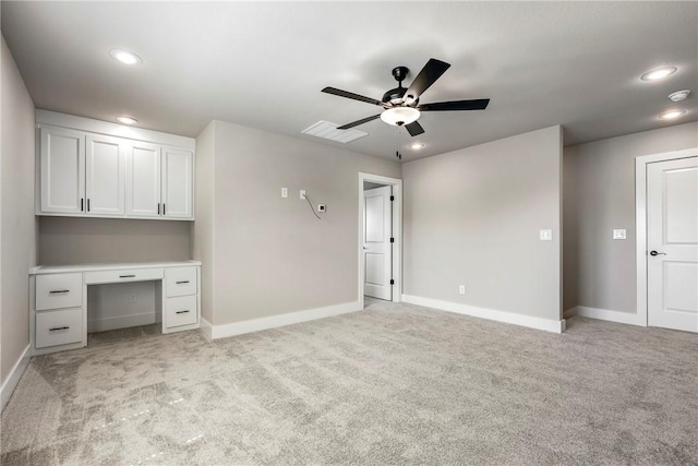 interior space with ceiling fan and light colored carpet