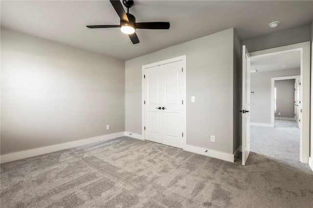 unfurnished bedroom with carpet, ceiling fan, and a closet