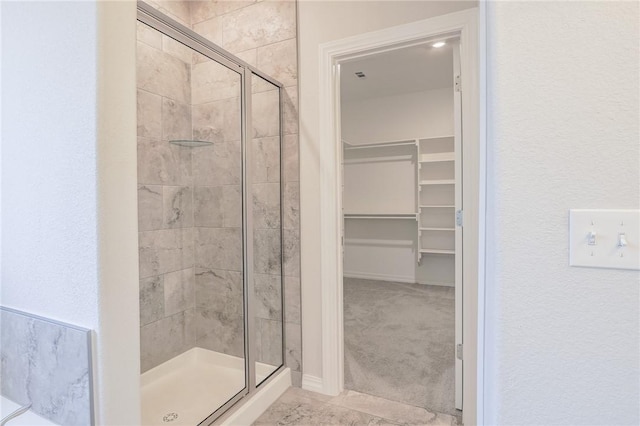 bathroom with a shower with door