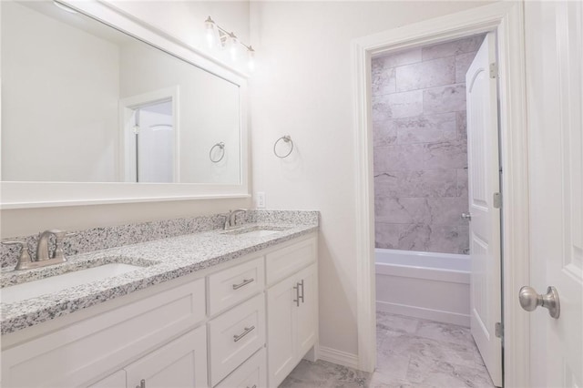 bathroom featuring vanity and tiled shower / bath