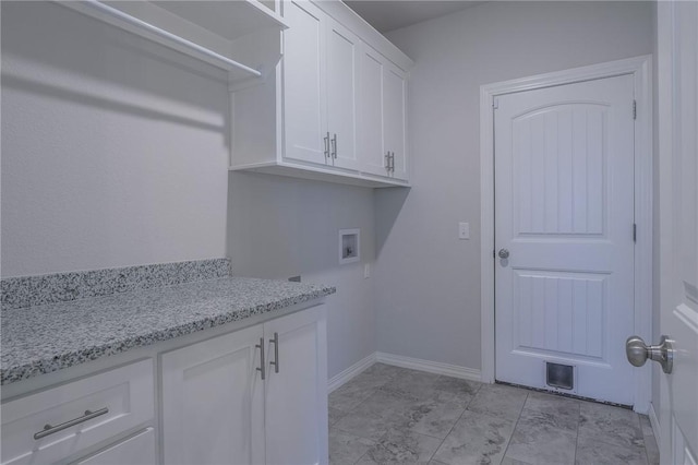 clothes washing area with hookup for a washing machine and cabinets