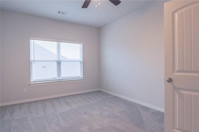 carpeted spare room featuring ceiling fan