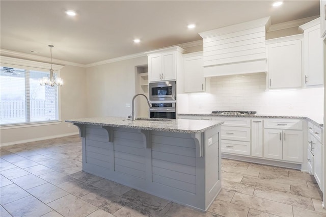 kitchen featuring white cabinetry, sink, a kitchen island with sink, and appliances with stainless steel finishes