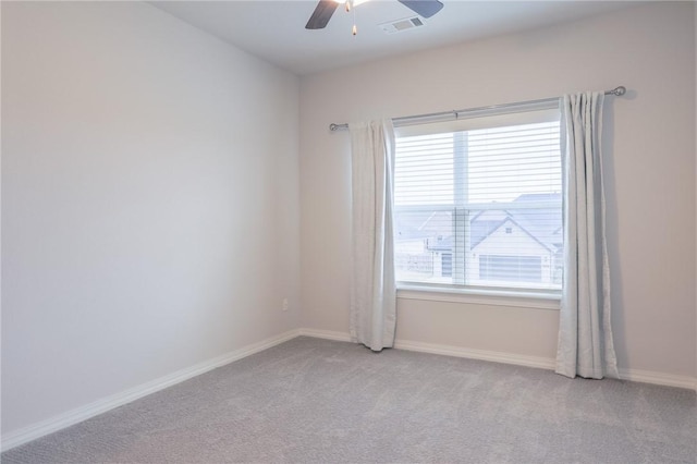 carpeted empty room featuring ceiling fan