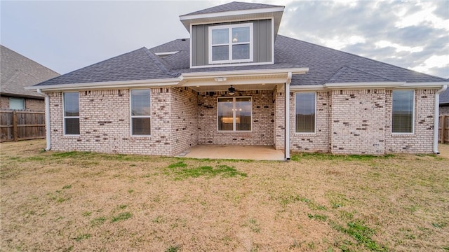 rear view of property with a yard and a patio