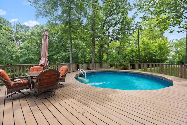 view of swimming pool with a deck and outdoor dining area