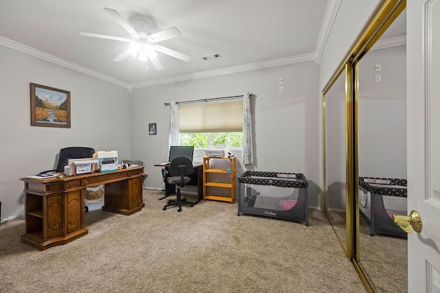 carpeted office space featuring a ceiling fan, visible vents, and crown molding