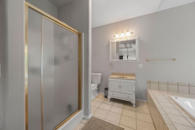 bathroom with toilet, vanity, a shower stall, and tile patterned floors