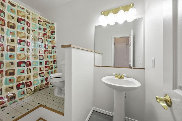 bathroom featuring a shower with shower curtain, toilet, and tile patterned floors