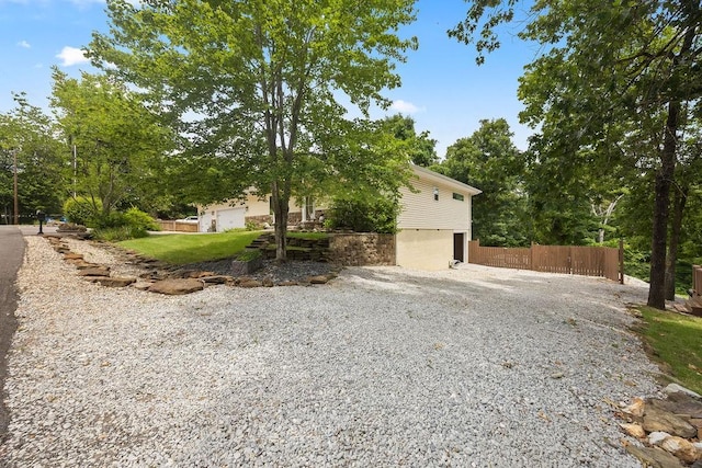 exterior space featuring driveway and fence