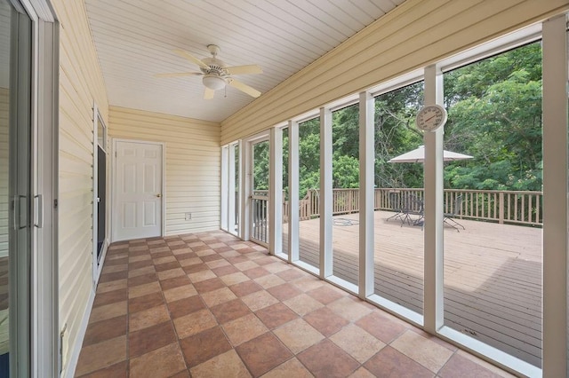 unfurnished sunroom with a ceiling fan