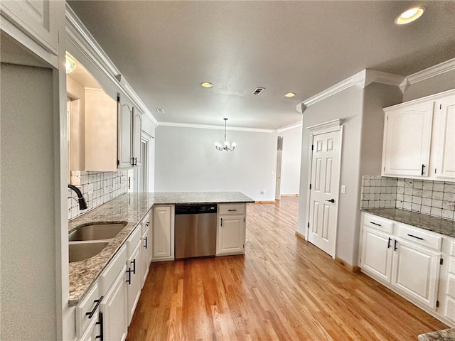 kitchen featuring light wood-style flooring, stainless steel dishwasher, white cabinetry, a sink, and a peninsula