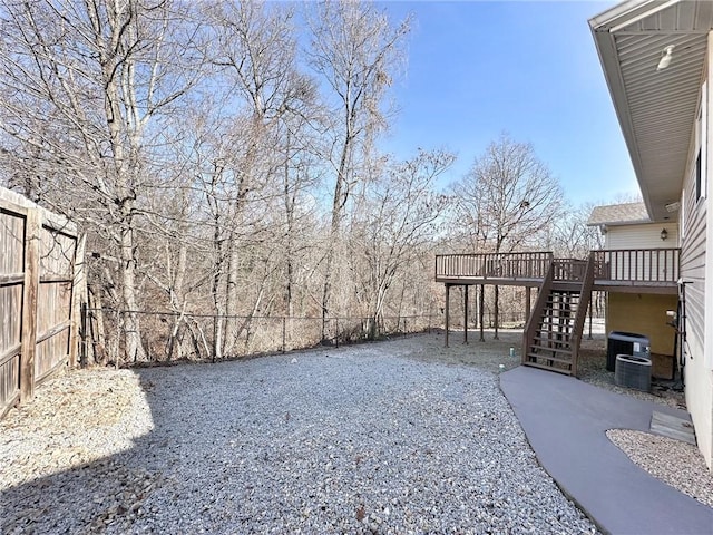 view of yard featuring a fenced backyard, stairway, a deck, and a patio