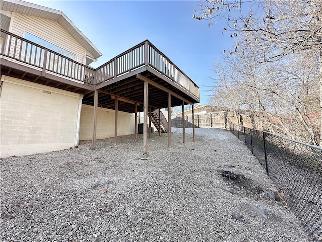 exterior space with a fenced backyard, stairway, and a wooden deck