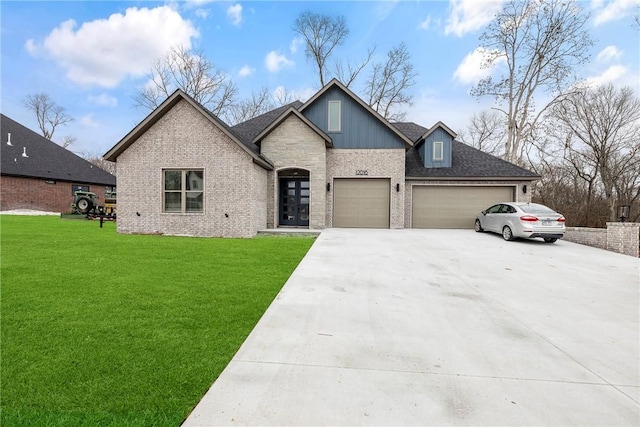 view of front of home with a front yard and a garage