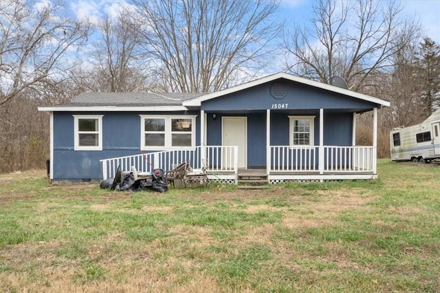 view of front of property with a front yard and a porch