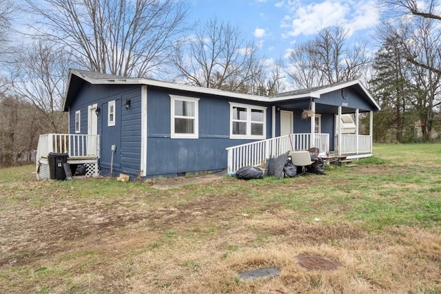 view of front of property with covered porch and a front lawn