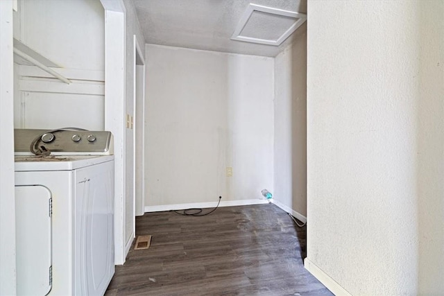 clothes washing area with dark hardwood / wood-style flooring and washer / clothes dryer