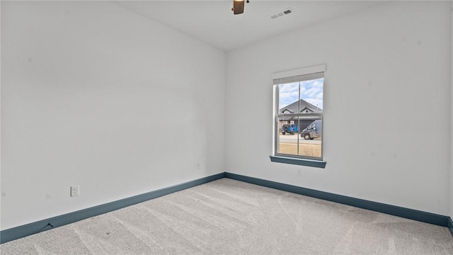 carpeted spare room with ceiling fan