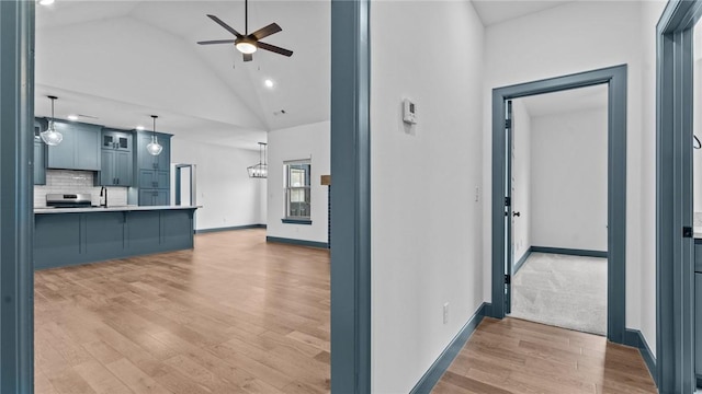 interior space with light hardwood / wood-style flooring, high vaulted ceiling, and sink