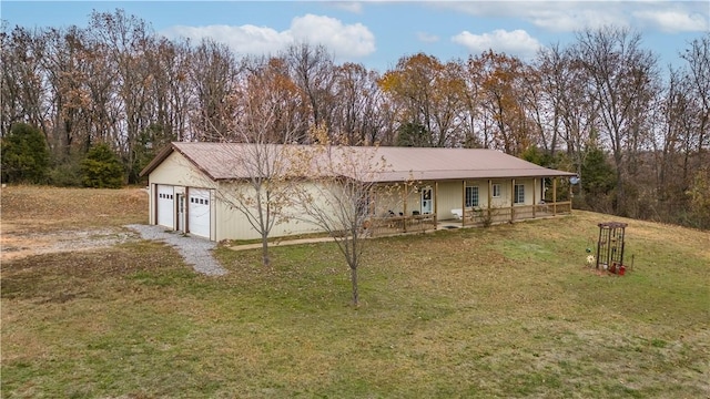 view of front of property with a garage, a porch, and a front yard