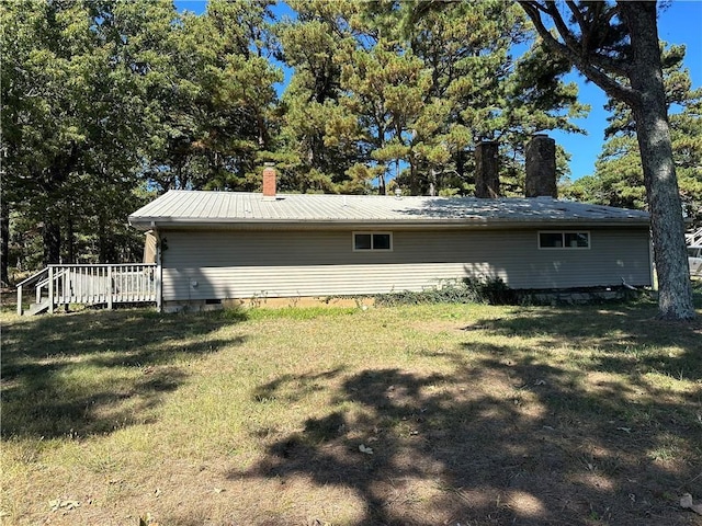 view of side of property featuring a wooden deck and a yard