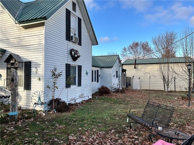 view of property exterior with a lawn