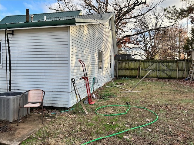 view of side of home with central AC unit