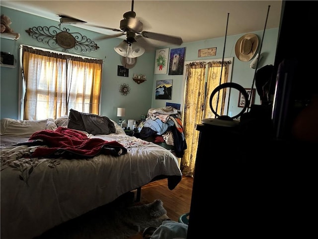 bedroom with ceiling fan and wood-type flooring