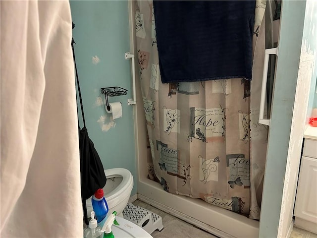 bathroom featuring tile patterned floors, shower / bath combination with curtain, and toilet