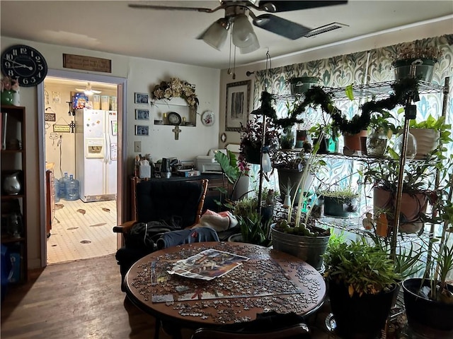 dining room with hardwood / wood-style flooring and ceiling fan