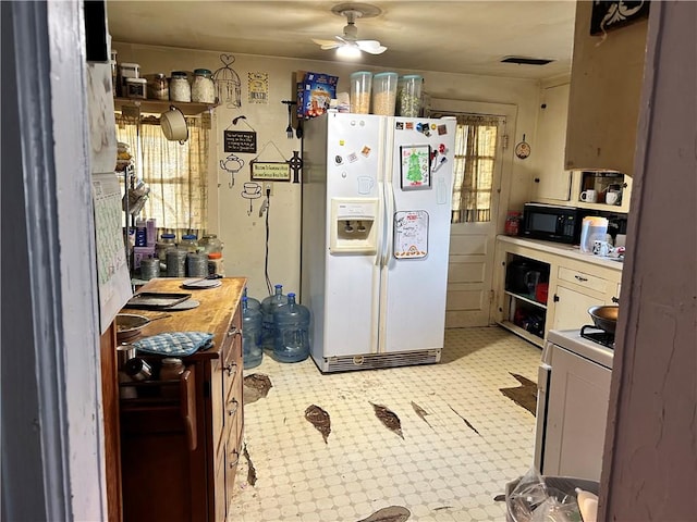 kitchen with white appliances and ceiling fan