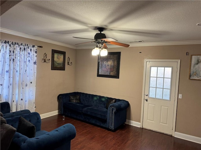 living room featuring ceiling fan, dark wood-type flooring, a textured ceiling, and ornamental molding