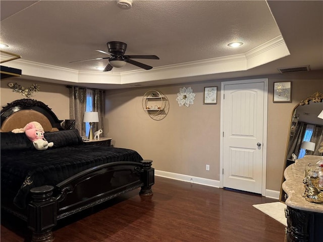 bedroom featuring a raised ceiling, crown molding, ceiling fan, a textured ceiling, and dark hardwood / wood-style flooring